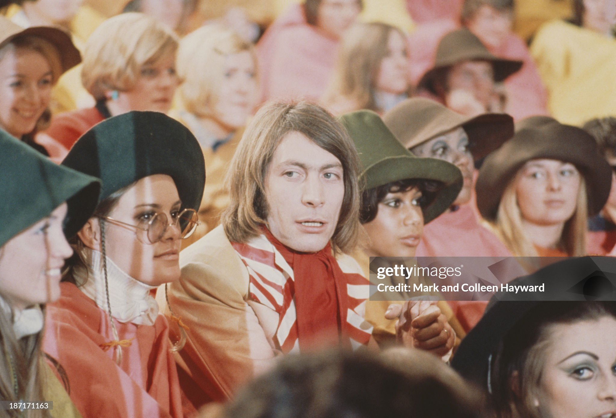 Drummer Charlie Watts from The Rolling Stones poses with members of the audience on the set of the Rolling Stones Rock and Roll Circus at Intertel TV Studio in Wembley, London, on 11 December 1968. 