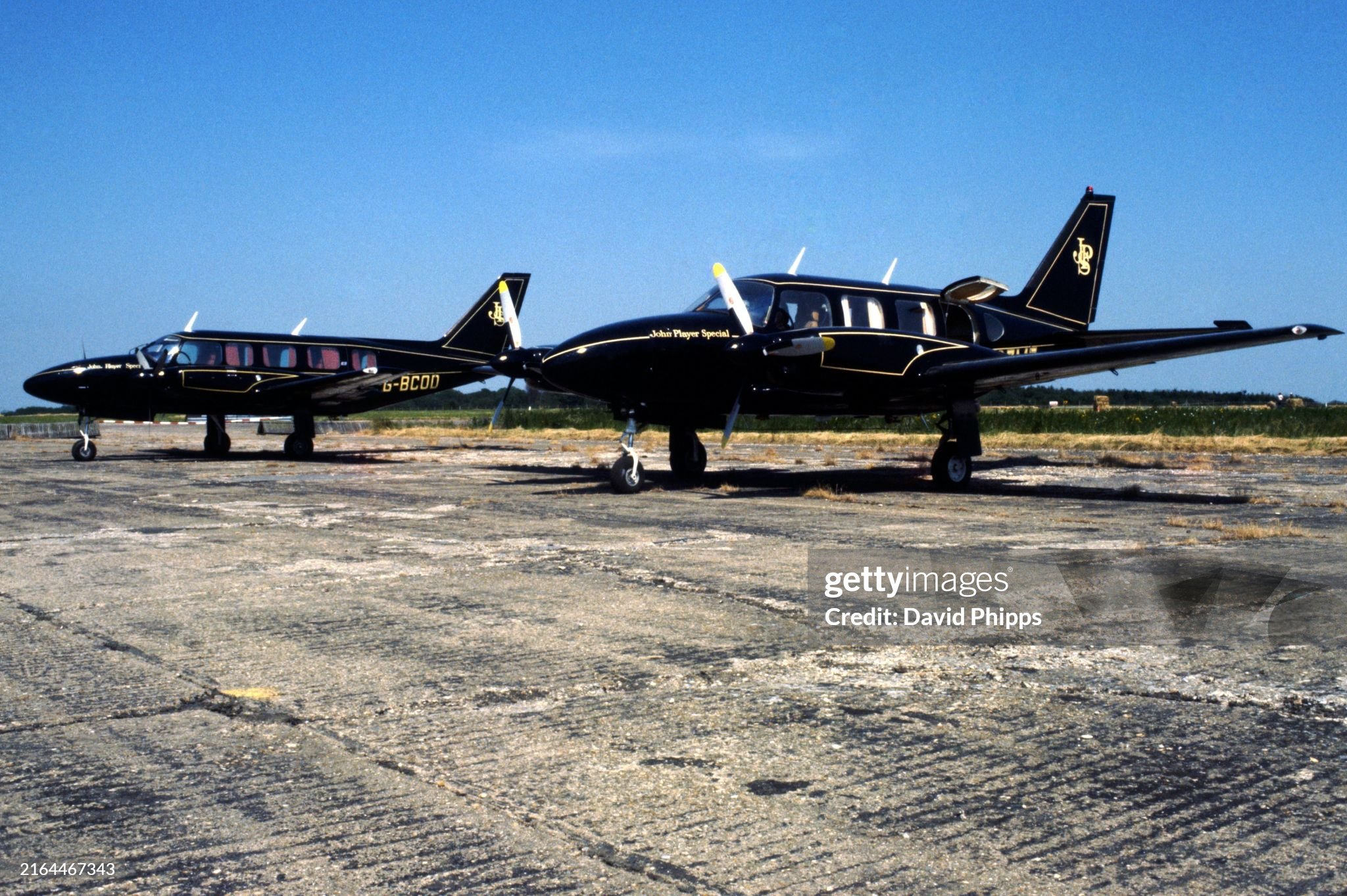 A pair of JPS liveried Piper Navajo Chieftains owned by Colin Chapman, Lotus Team owner, sit on the runway at Silverstone for the British Grand Prix on 16 July 1977. 