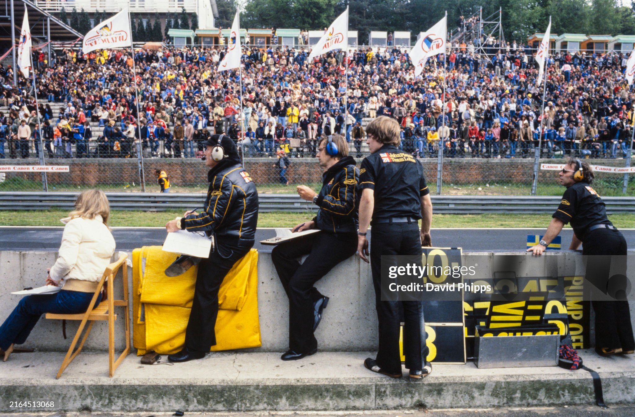 Colin Chapman and the Lotus engineers monitor timings and wait with the pit boards during the race. Left to right: Barbro Peterson, Colin Chapman and designer Nigel Bennett during the Belgian Grand Prix in Zolder on 21 May 1978. 
