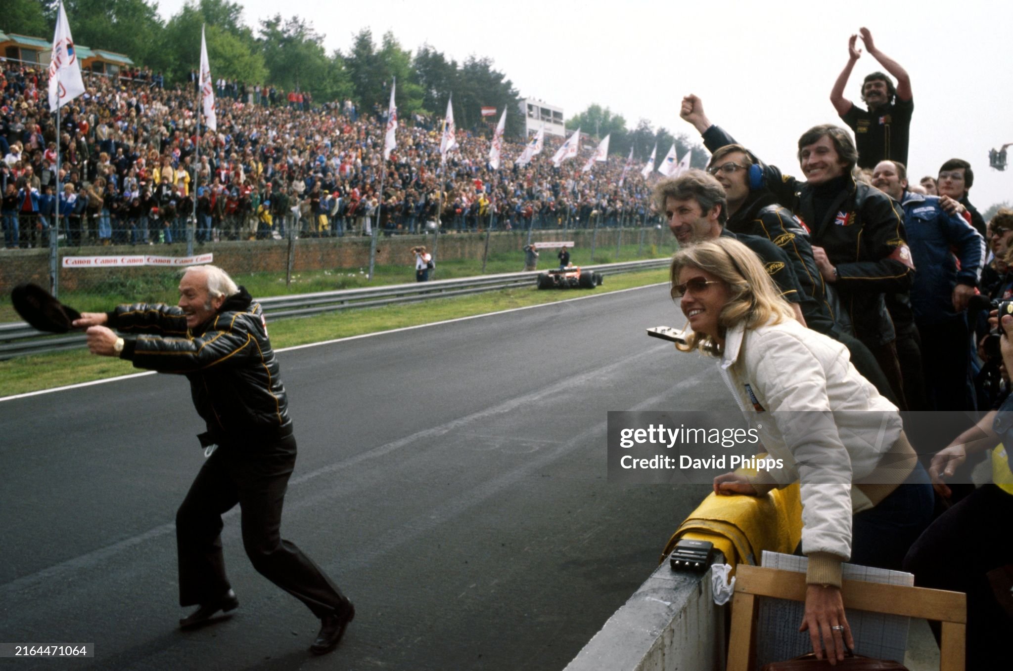 Colin Chapman and the Lotus team, including Barbro Peterson, Bob Dance, Lotus mechanic, Nigel Bennett, Lotus chief race engineer and Glenn Waters, Lotus mechanic, celebrate victory for Mario Andretti and second position for team mate Ronnie Peterson at the Belgian Grand Prix in Zolder on 21 May 1978. 