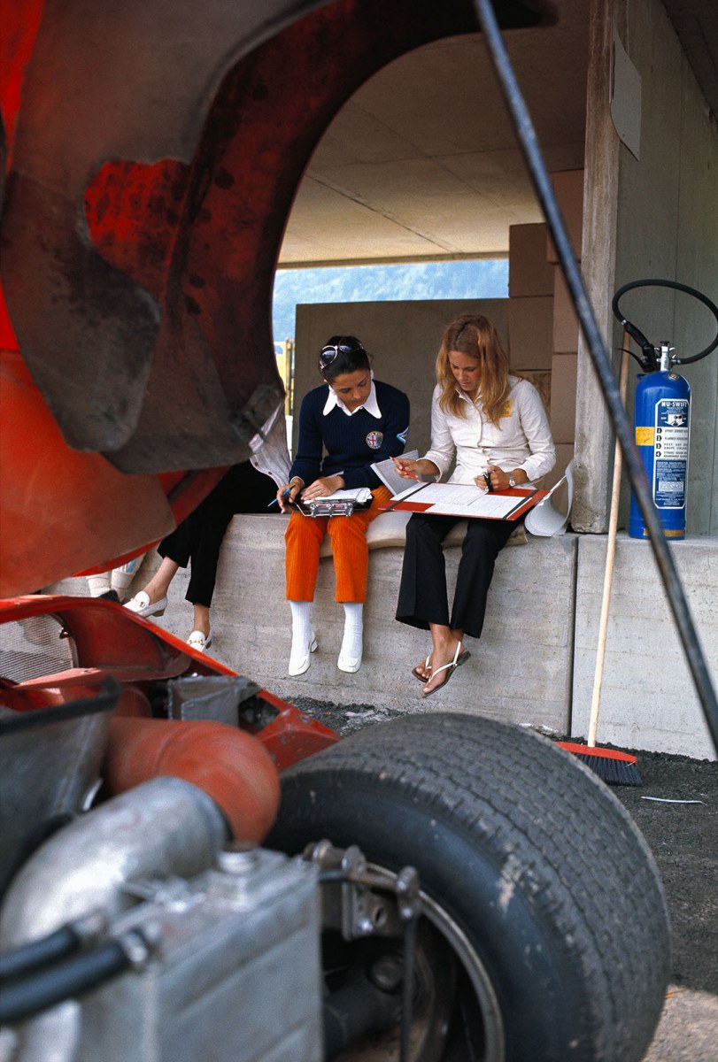 Timekeeping girls sit on the pit wall at Zeltweg. 
