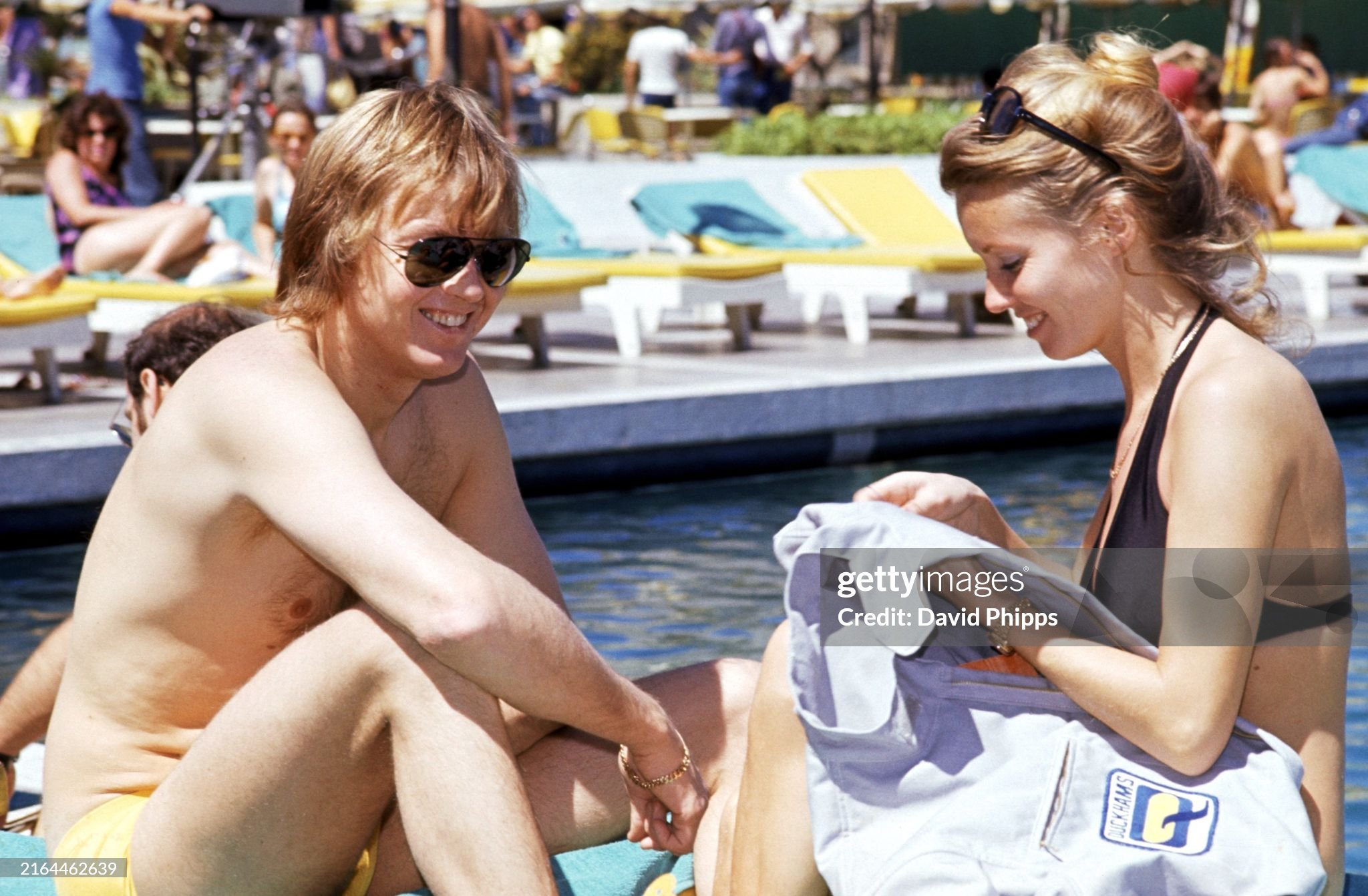 Ronnie Peterson relaxes with his wife Barbro Edwardson who sews patches onto his race overalls at the Kyalami Ranch Hotel during the South African Grand Prix on 30 March 1974. 
