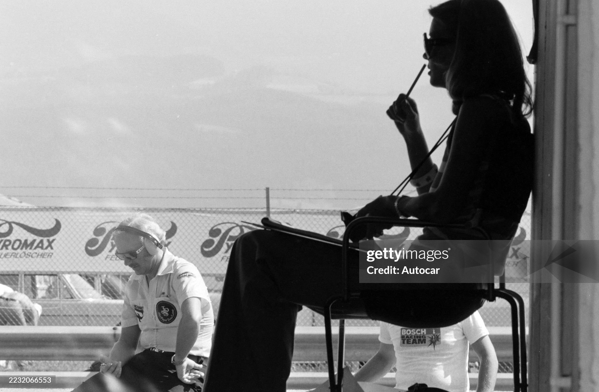 Barbro Peterson and Colin Chapman keep track of the times from the pit lane during the Austrian Grand Prix at Red Bull Ring on 18 August 1974. 
