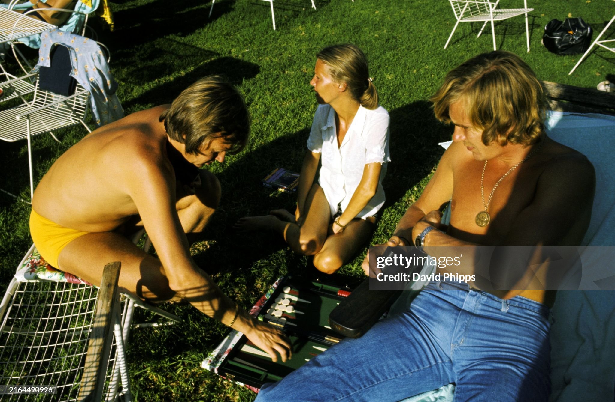 Tenth placed Ronnie Peterson with wife Barbro enjoys a game of Backgammon with race retiree James Hunt, Hesketh, at the Kyalami Ranch Hotel at the South African Grand Prix on 01 March 1975. 