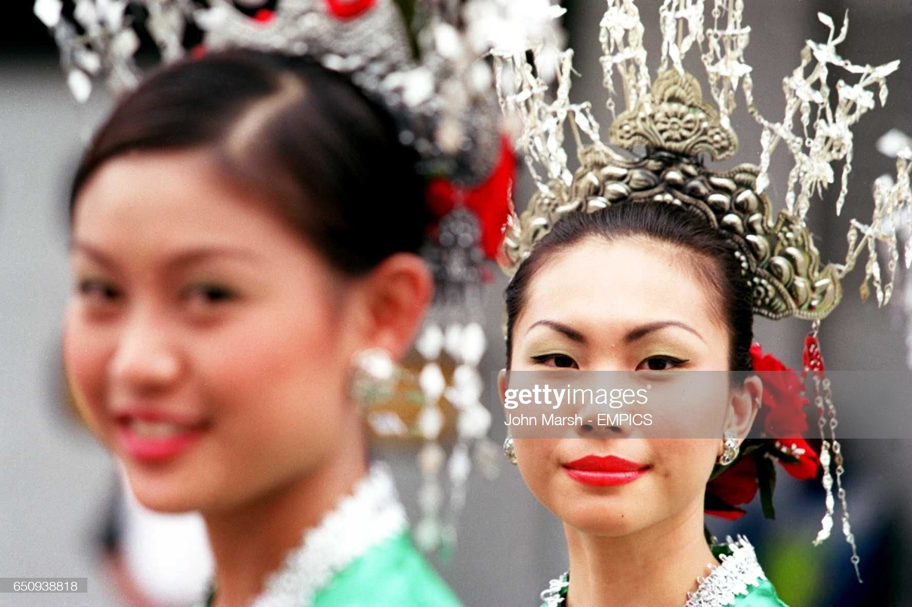Malaysian girls in traditional costume on the grid before the race on October 22, 2000. 