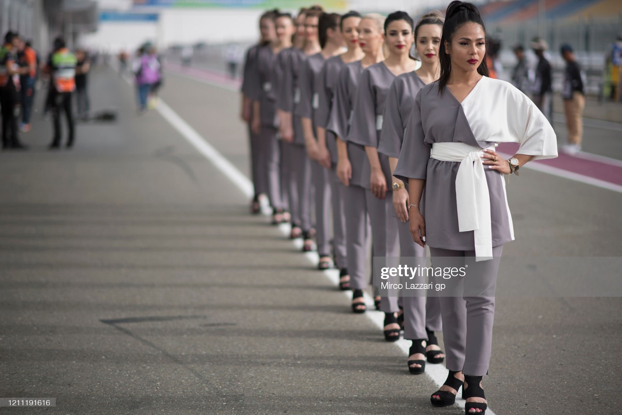 The grid girls pose in the pits before the grid during the Moto4 race during the Moto2 and Moto3 GP of Qatar races at Losail Circuit on March 08, 2020 in Doha, Qatar. 