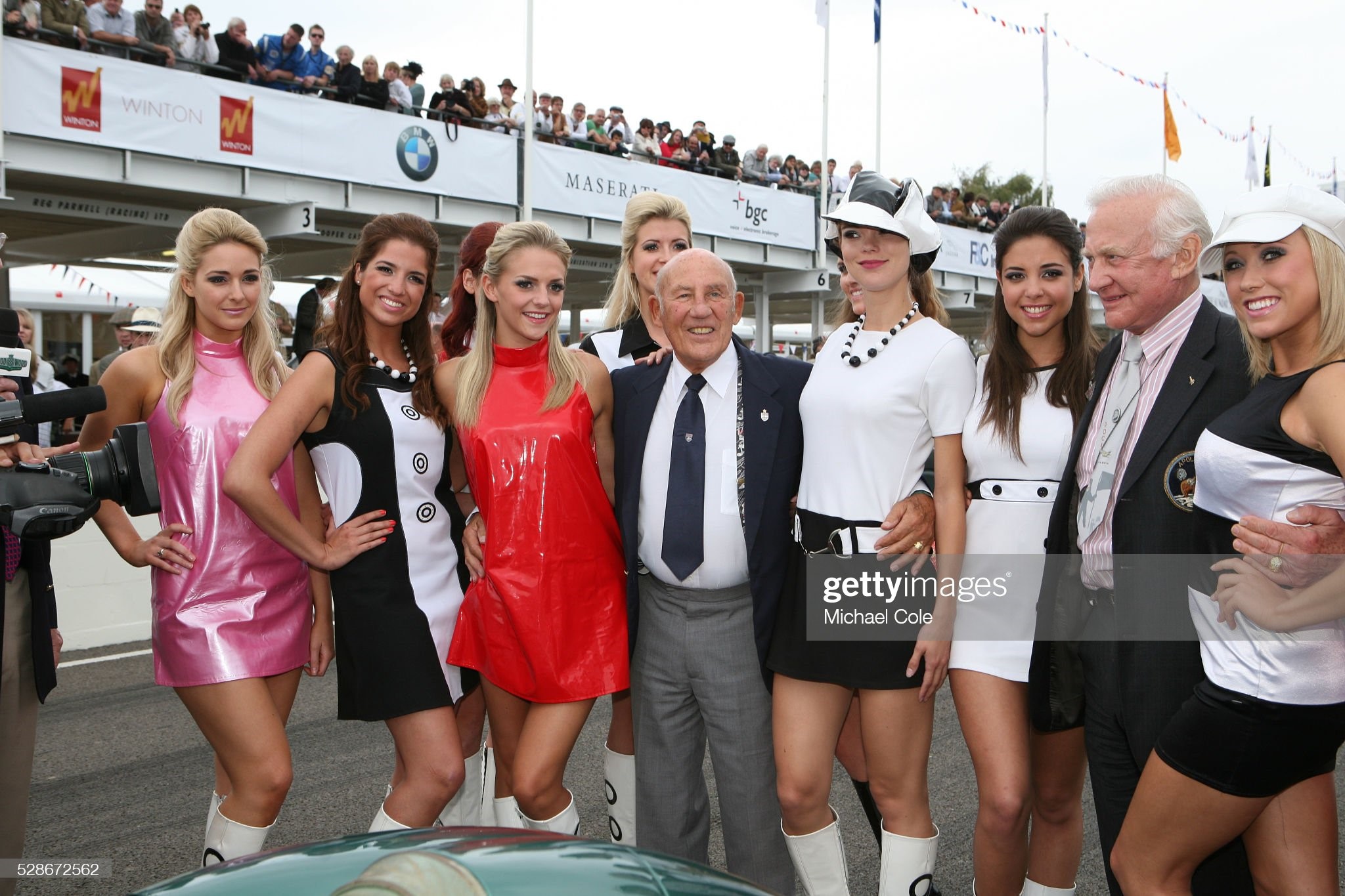 Sir Stirling Moss and Buzz Aldrin, of Apollo 11, surrounded by the starting grid girls at the Goodwood Revival Meeting on September 20, 2009. 