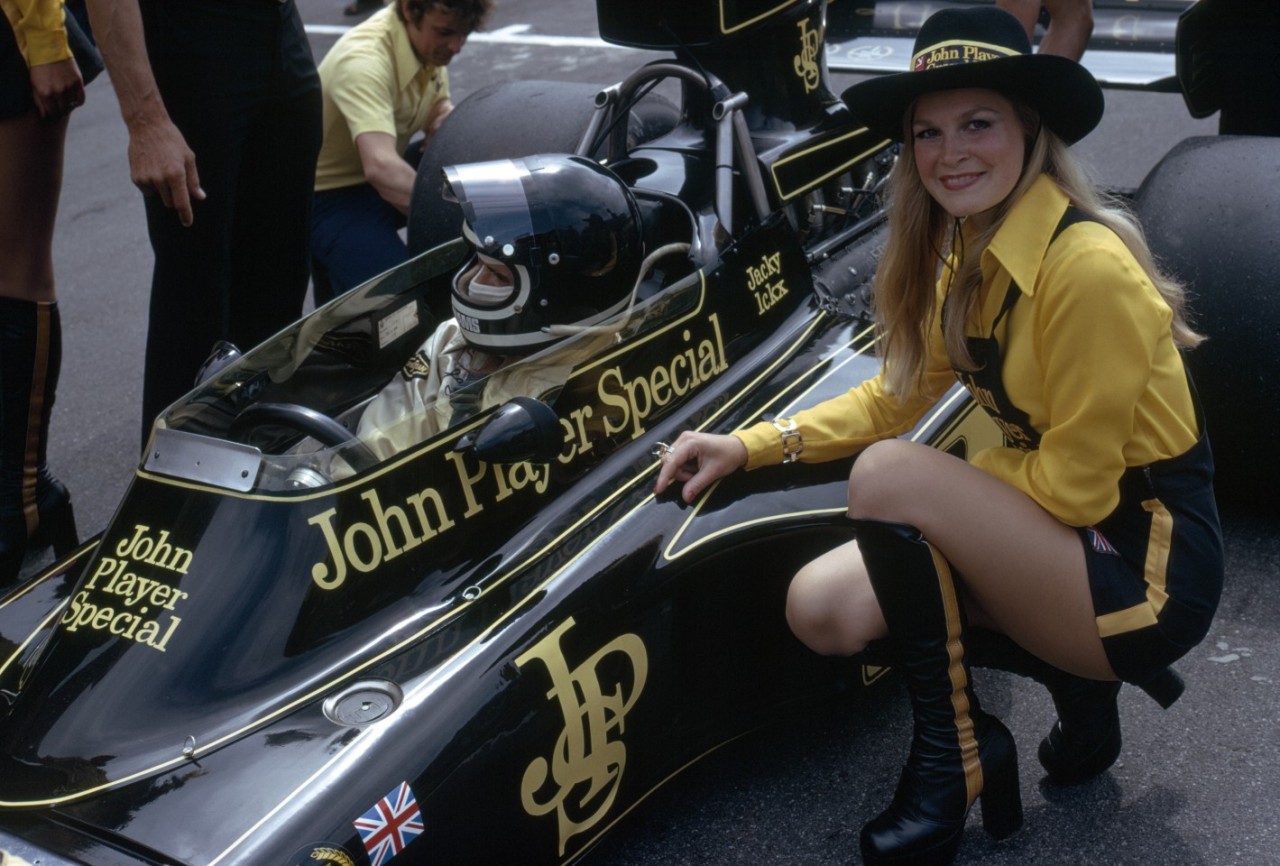 Jacky Ickx in a Lotus with a grid girl.