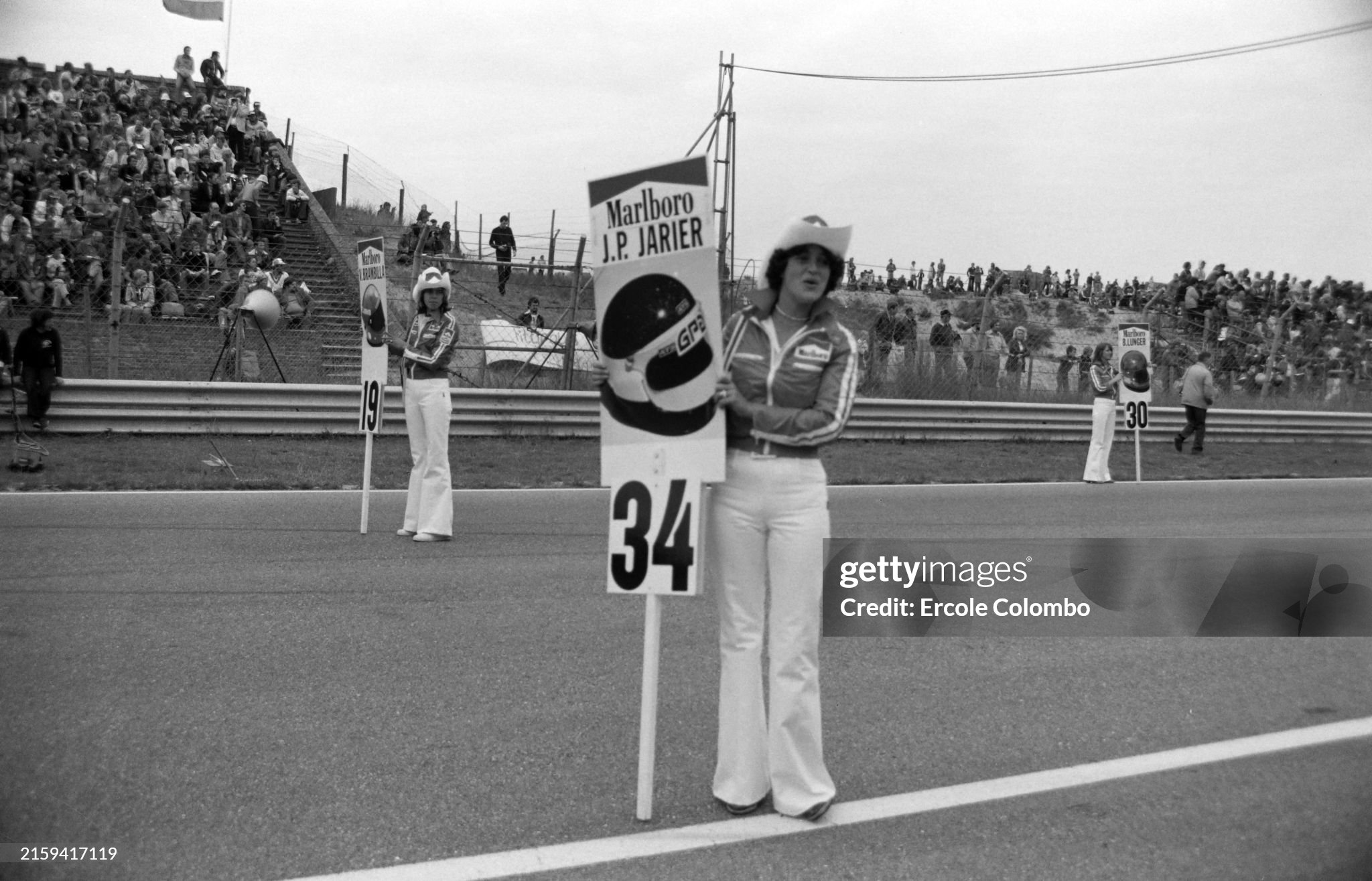 The grid girls holding signs showing where the drivers are to line up on the grid for the Dutch Grand Prix at Zandvoort on 28 August 1977. 