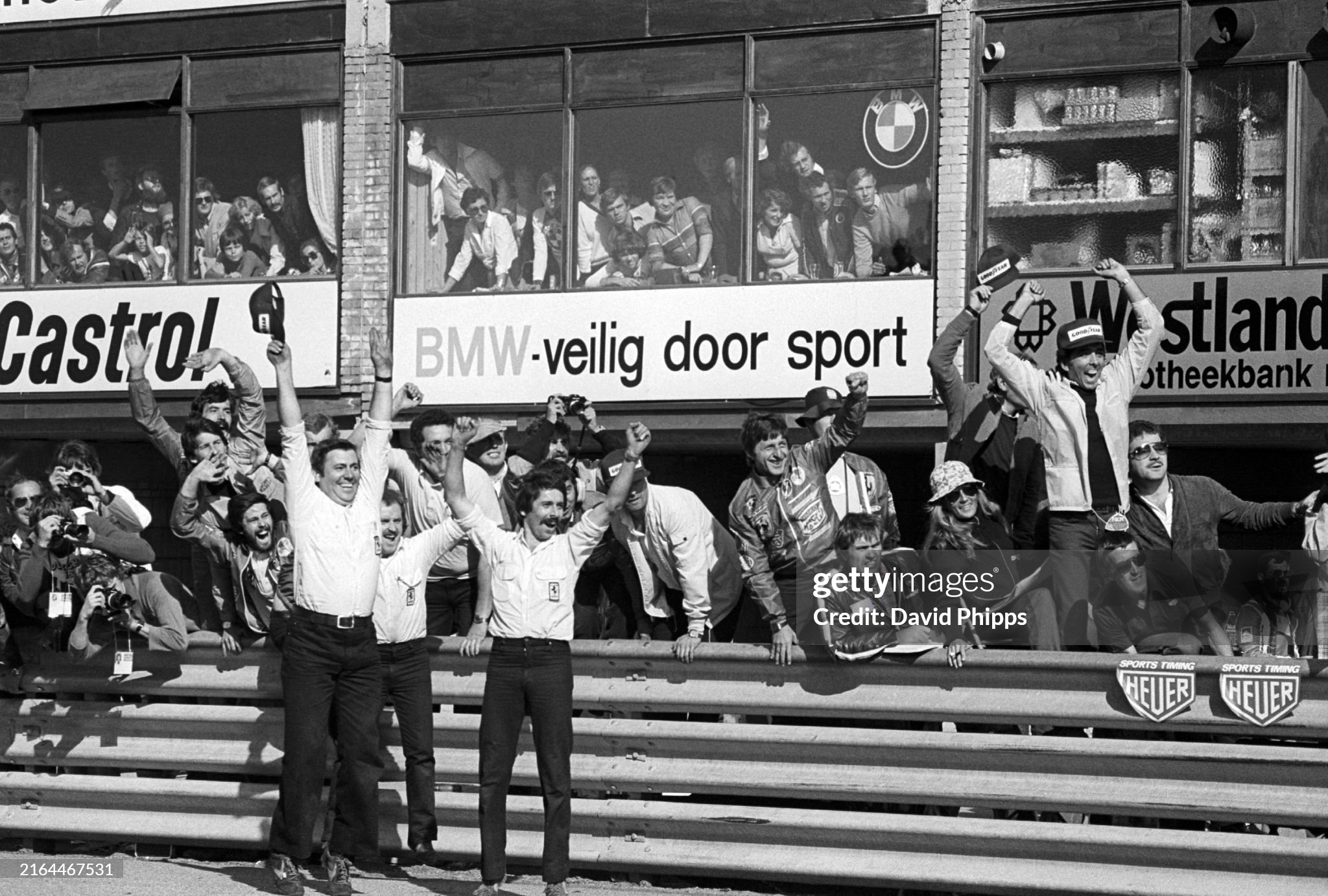 The Ferrari team celebrate from the pit wall as Niki Lauda takes victory in the Dutch Grand Prix at Zandvoort on 28 August 1977. 