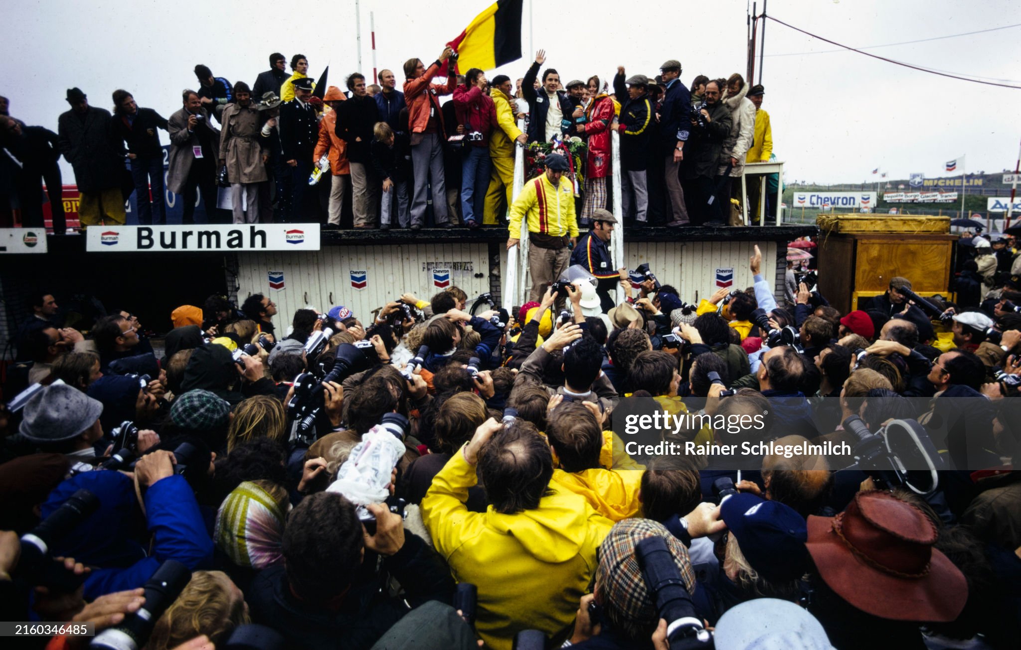 A crowd gathers to see race winner Jacky Ickx on the podium after the Dutch Grand Prix at Circuit Zandvoort on Sunday June 20, 1971. 