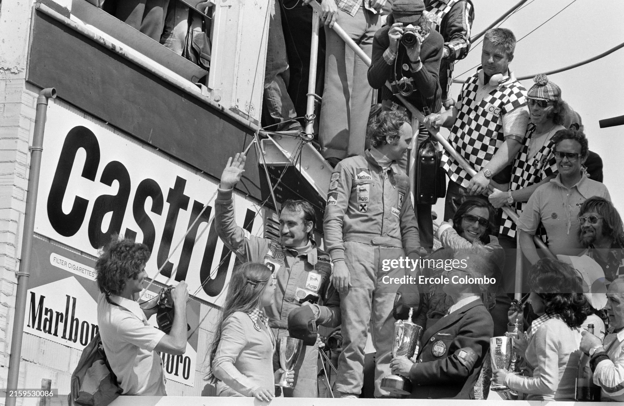 Niki Lauda, 1st position, Clay Regazzoni, 2nd position and Emerson Fittipaldi, 3rd position, celebrate on the podium after the Dutch Grand Prix in Zandvoort on 23 June 1974. 