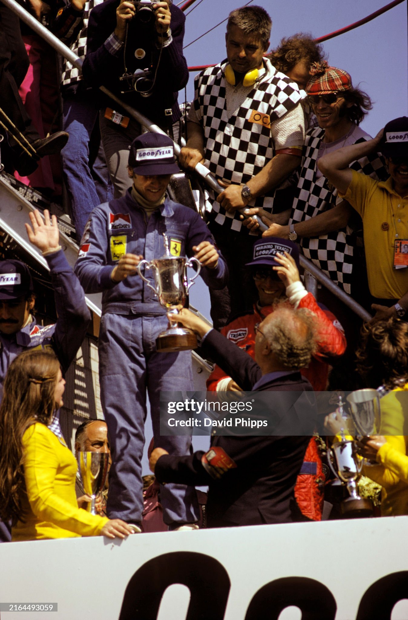 Niki Lauda, 1st position, Clay Regazzoni, 2nd position and Emerson Fittipaldi, 3rd position, celebrate on the podium after the Dutch Grand Prix in Zandvoort on 23 June 1974. 