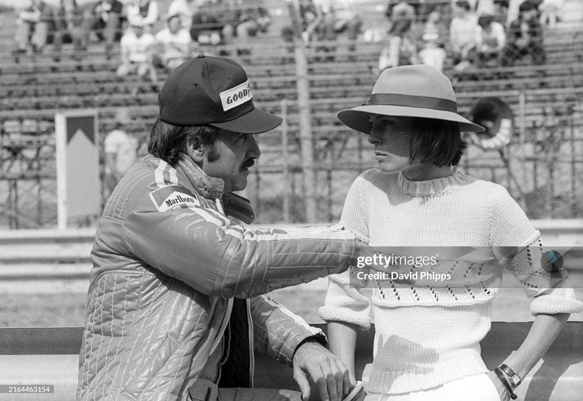 Third placed Clay Regazzoni, Ferrari, talks with Mariella Reininghaus, the fiancee of Niki Lauda, Ferrari, at the Dutch Grand Prix in Zandvoort, Holland, on 22 June 1975. 