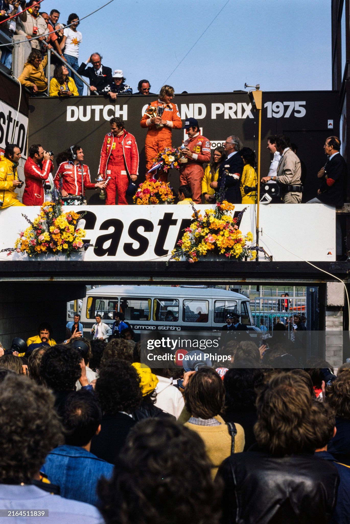 James Hunt, Hesketh Ford, 1st position, Niki Lauda, Ferrari, 2nd position and Clay Regazzoni, Ferrari, 3rd position on the podium of the Dutch Grand Prix in Zandvoort, Holland, on 22 June 1975. 