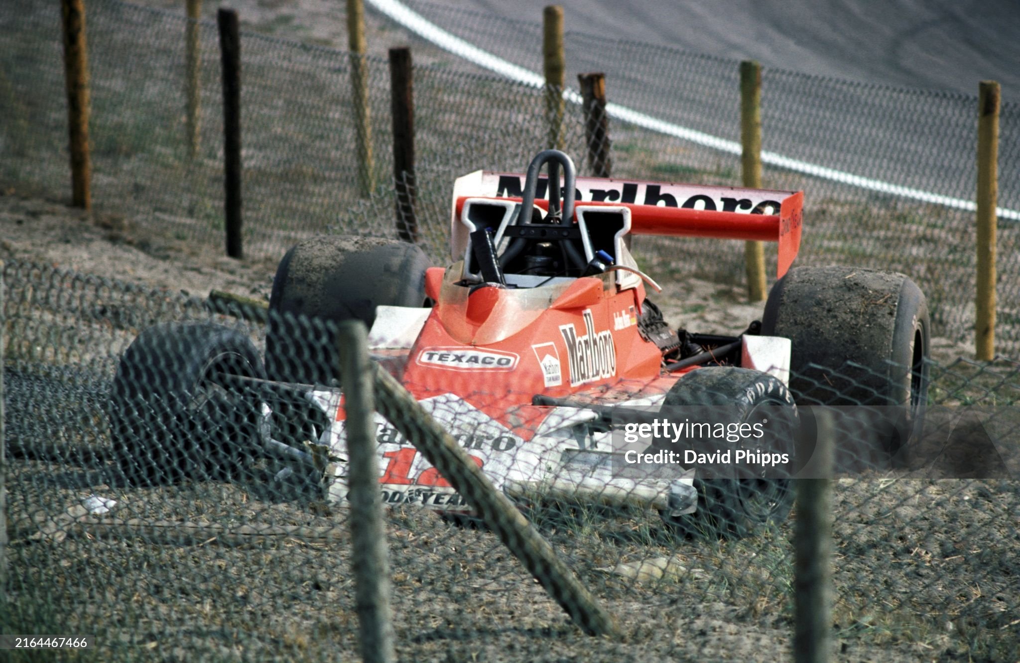 The new McLaren M26 of Jochen Mass sits in the catch fencing after an off during practice. Jochen went on to finish the new car in ninth position in the Dutch Grand Prix at Zandvoort on 29 August 1976.