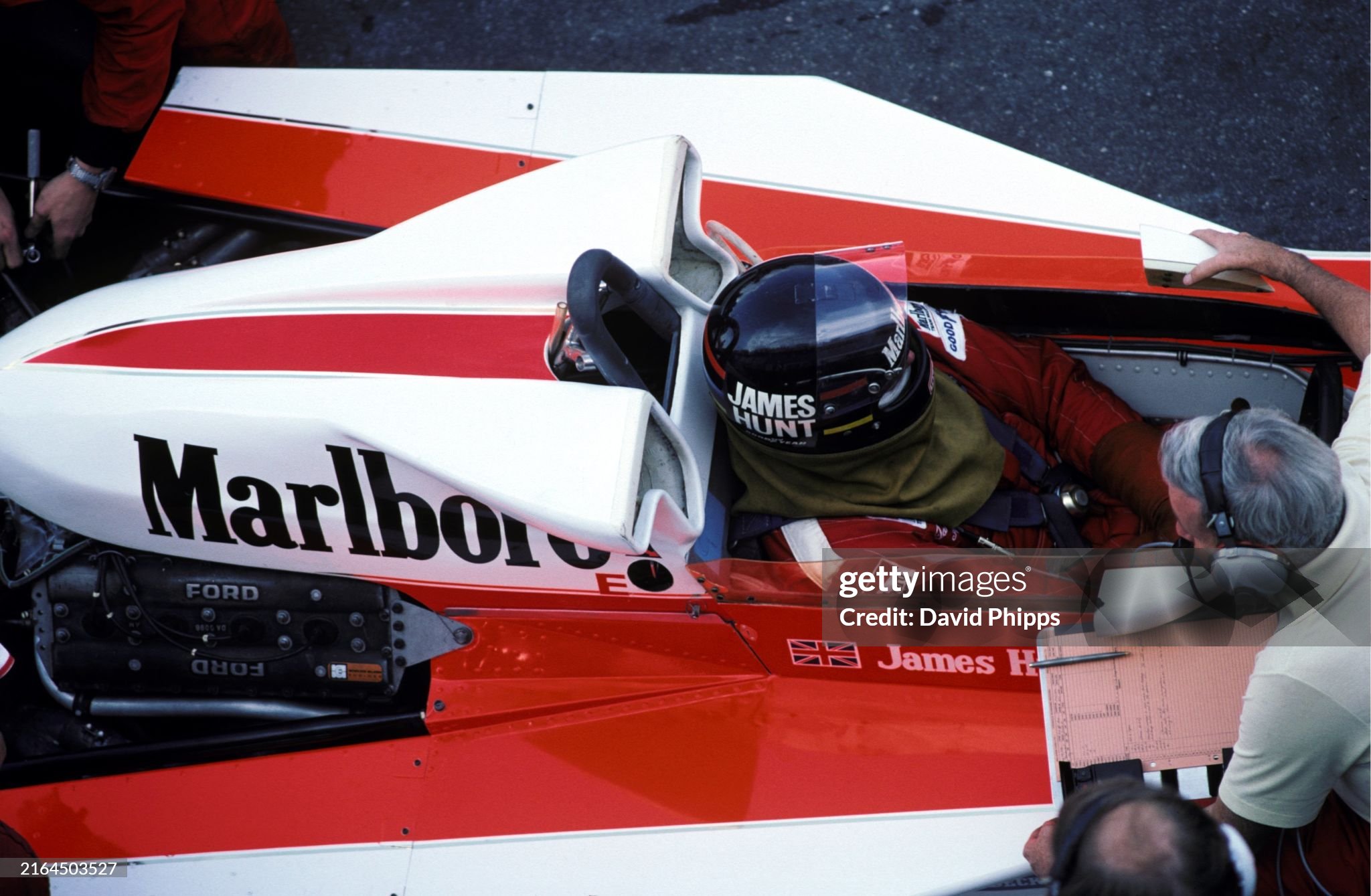 Race winner James Hunt, McLaren M23, talks with Teddy Mayer, McLaren Team owner, via a wired link-up in the pits during the Dutch Grand Prix at Zandvoort on 29 August 1976. 