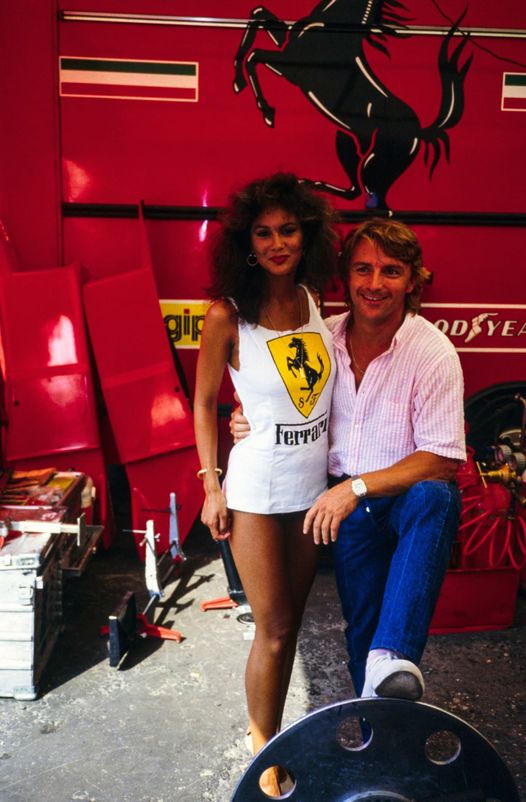 Rene' Arnoux with a female fan in the back of the Ferrari pits at Zandvoort on 26 August 1984.